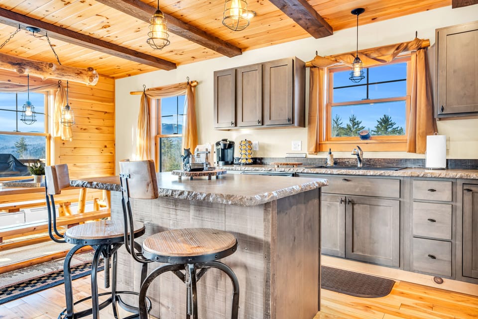 Fully stocked kitchen with stainless steel appliances and concrete counter tops
