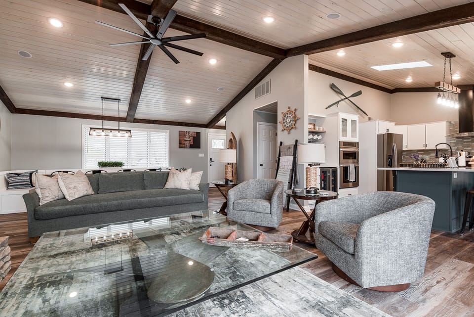 Open concept living room with 65" Roku TV; books, games, sliding door to deck
