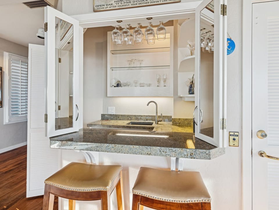 Bar with sink and fridge.