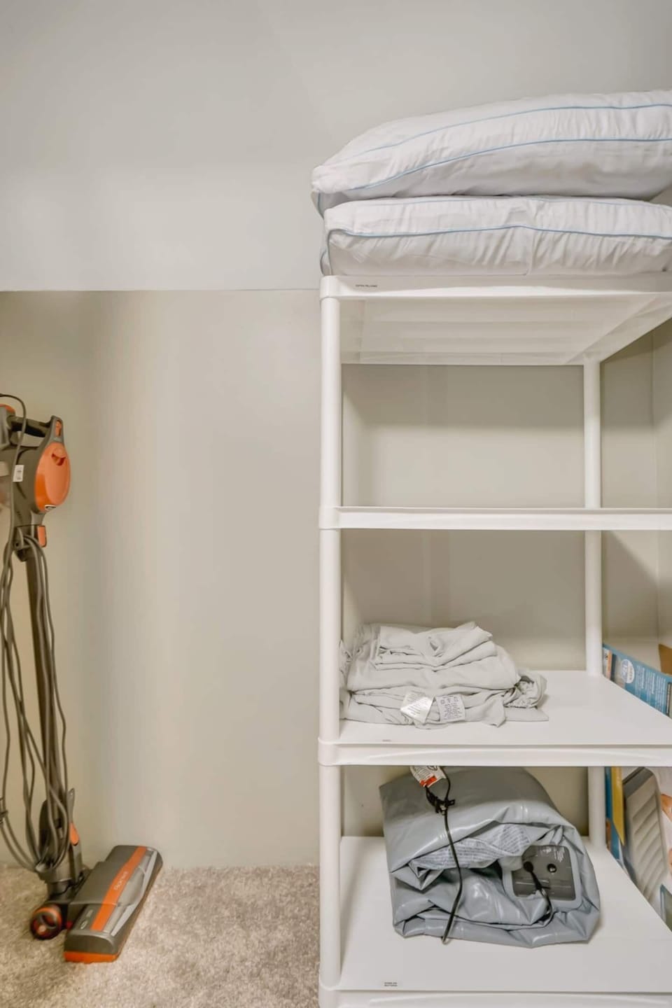 Closet on the second floor. This closet includes a queen size air mattress, additional sheets, pillows and a blanket as well as the vacuum for guests use.