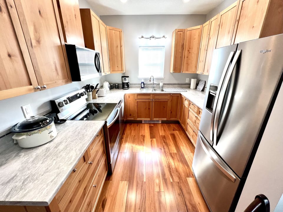 Your culinary haven awaits: Stove, coffee maker, full-size fridge.