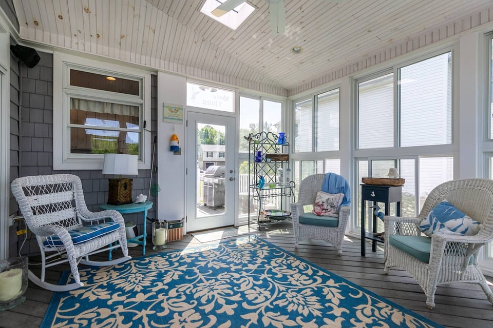 The sunporch has access to both the back deck and the front smaller deck with the propane grill.