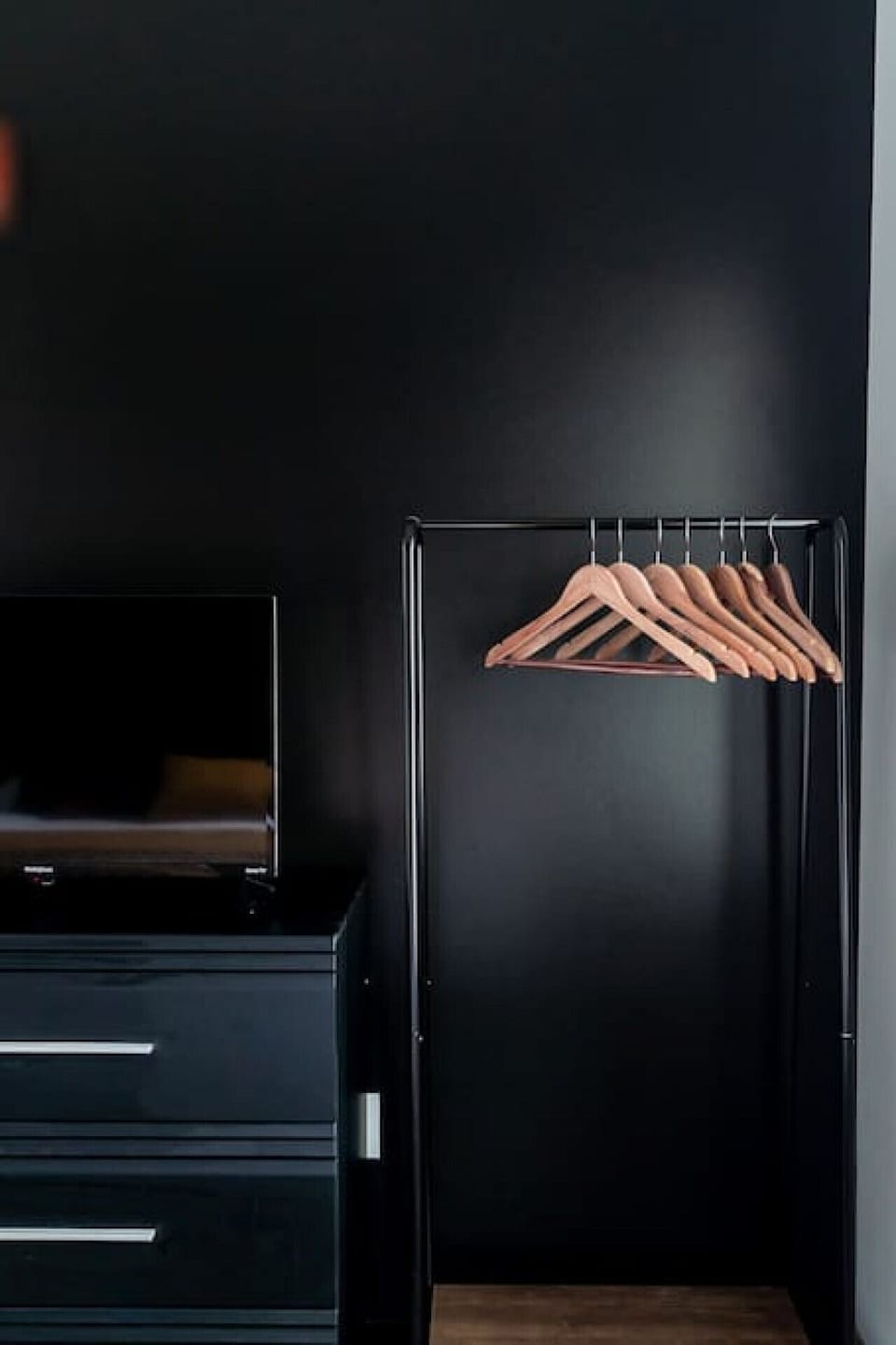 Comfortable King size bed in bedroom #1. Hanging Rack + Dresser to store your clothes in.