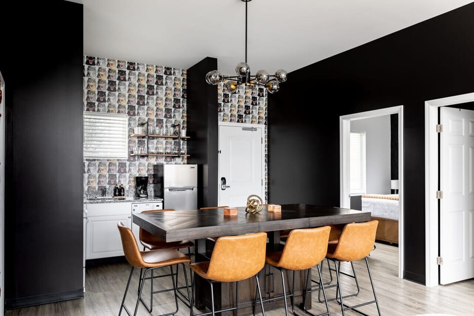 Fully equipped kitchen with drip coffee maker + coffee. Dining table with seating for 8. Full length mirror for getting ready. This room opens up into the living room. Unique wallpaper all throughout the condo.