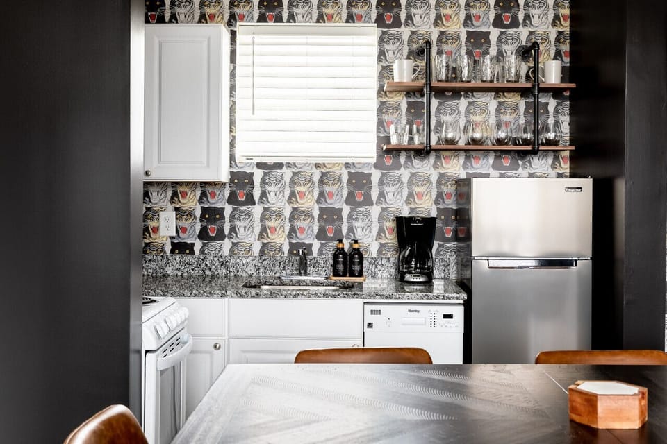 Fully equipped kitchen with drip coffee maker + coffee. Dining table with seating for 8. Full length mirror for getting ready. This room opens up into the living room. Unique wallpaper all throughout the condo.