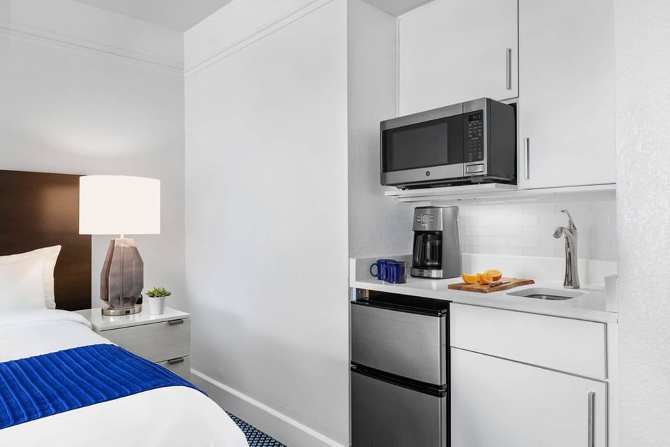 Kitchenette includes sink, microwave, mini fridge, and coffee maker.