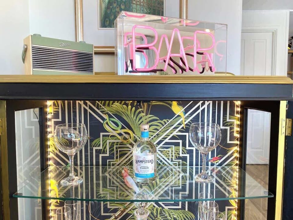 Play a few relaxing tunes on the Roberts DAB Radio & Bluetooth speaker. Illuminate the bar sign for a cosy ambience.