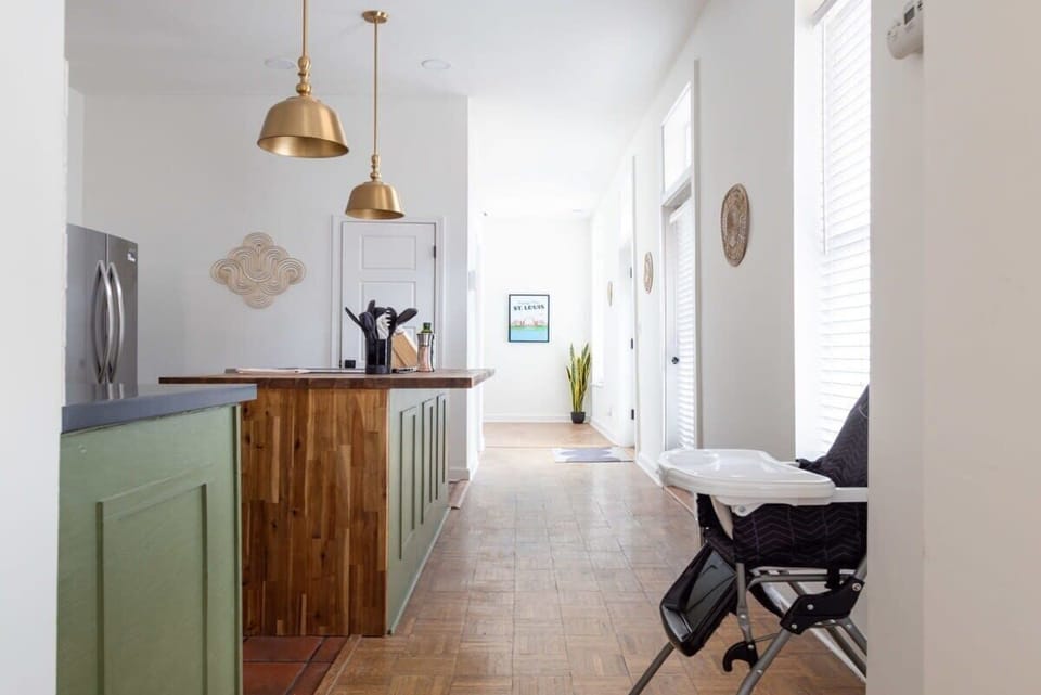 A bright kitchen with a spacious island that makes it easy to cook, chat, and gather before heading out to explore St. Louis. #AirbnbKitchen #HomeAwayFromHome