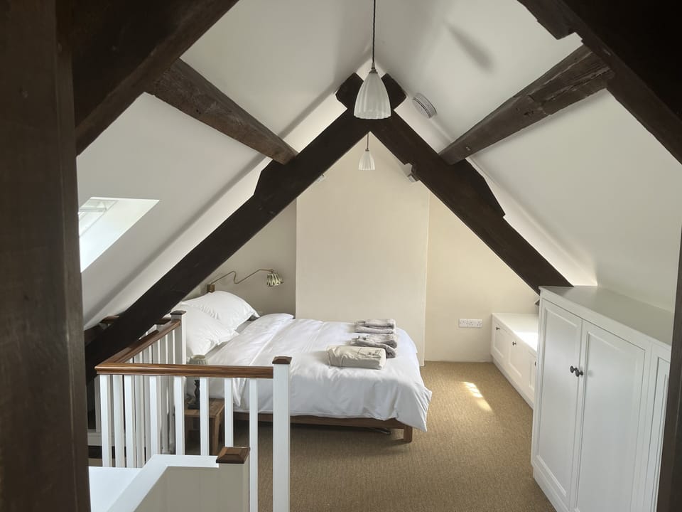 Character-packed bedroom, dormer window, open trusses, built-in storage