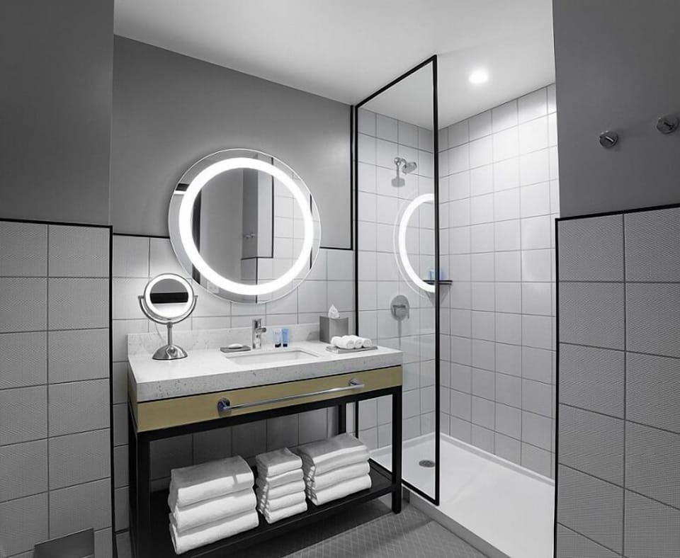 Enjoy a spotless bathroom with modern lighting and storage.