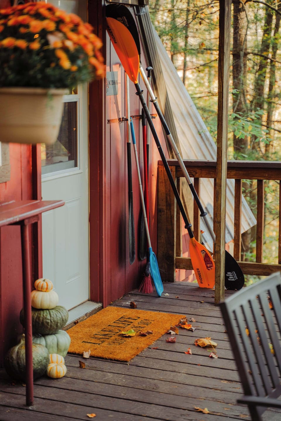 Welcoming Entrance: Step into adventure with colorful paddles and autumn charm at your door!