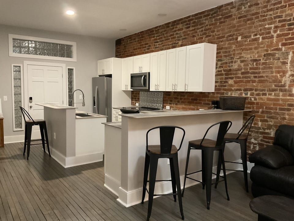 Counter seating for 4 plus a table and fold down chairs in the closet.