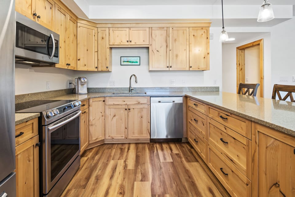Well-stocked kitchen w/ electric stove, oven, dishwasher, fridge and microwave.