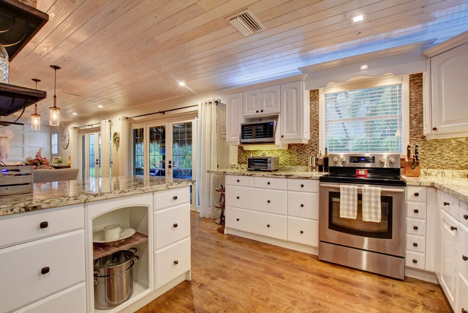 Open air kitchen, dining area, and living room, which open onto cabana and pool!