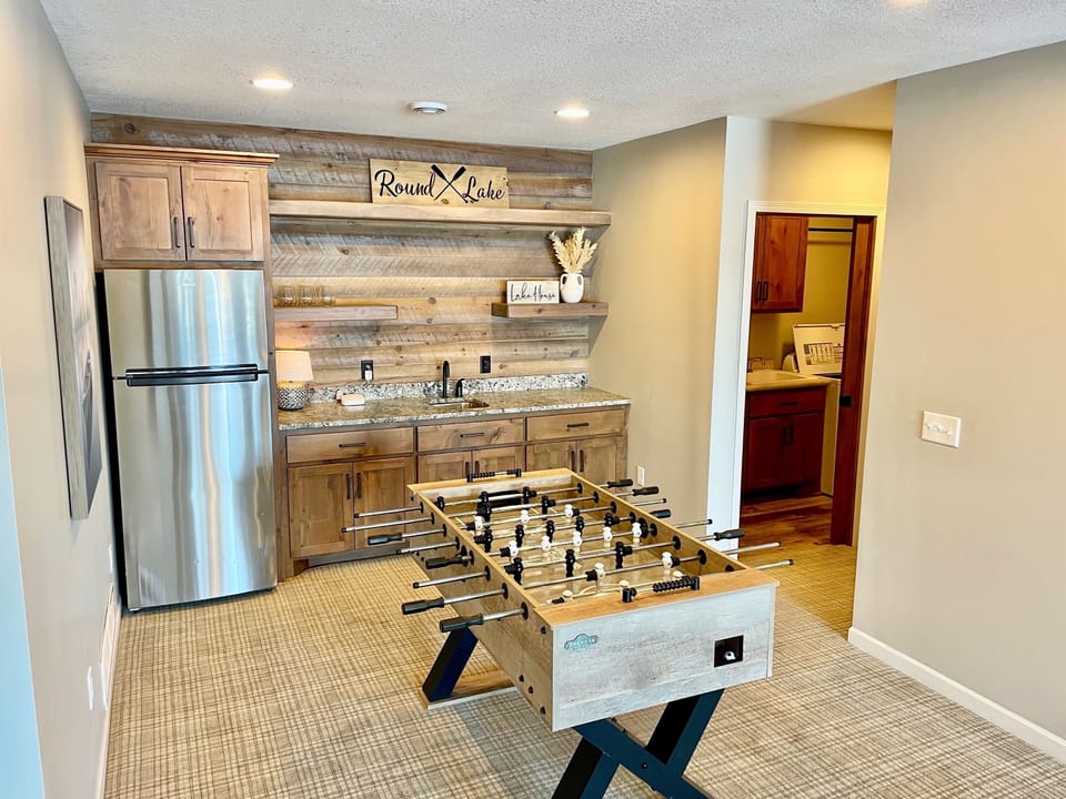 Wet bar in lower level. New foosball table. 