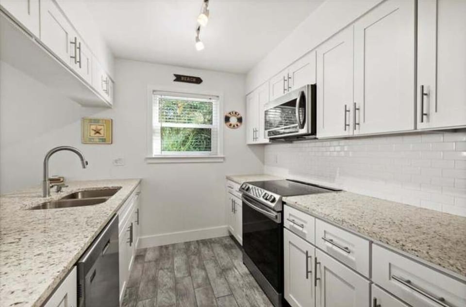 Lots of granite counter space and all you need is in this well-equipped kitchen.