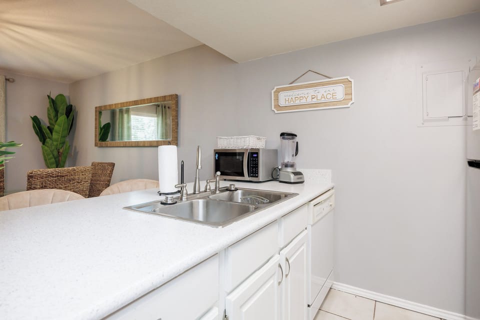 Your bright kitchenette awaits with everything you need—microwave, blender, and sink ready for easy meal prep in your happy place.