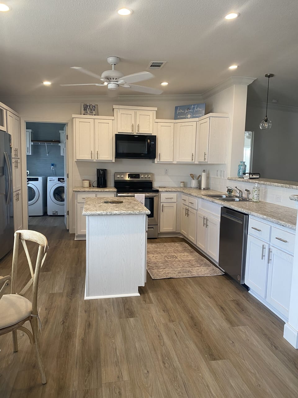 Kitchen w/washer and dryer and full sink in separate room.