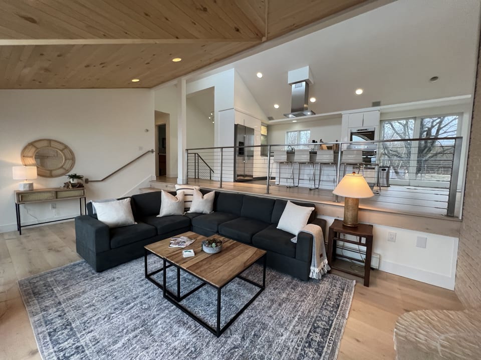 Sunken living room with fireplace and TV.  Deck access on the lake side.