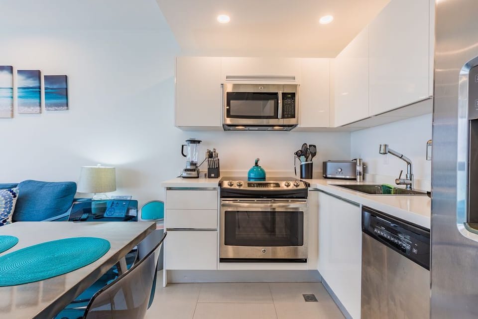 A sleek, coastal-inspired kitchen where you'll enjoy cooking with modern appliances and ample counter space, all bathed in natural light.