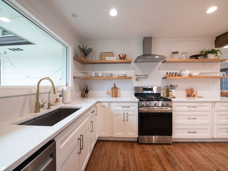 Our farmhouse style sink overlooks the back yard with a huge window and has a Water Drop water filter.
