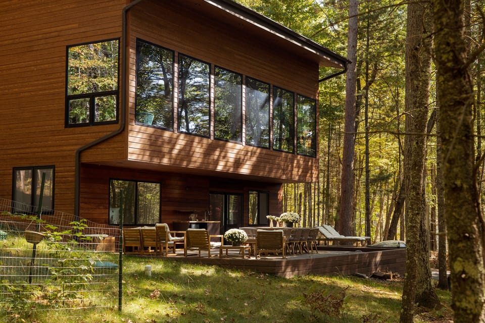 Back terrace with hut tub and furniture for relaxation overlooking the lake