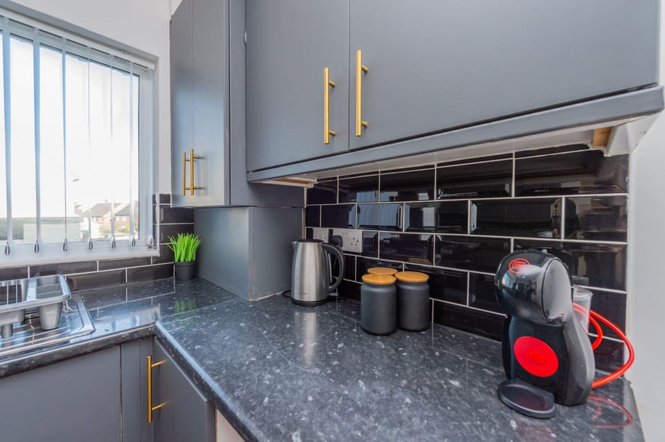 Fully equipped kitchen with appliances including coffee maker