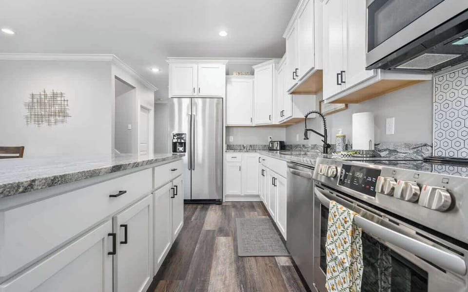 A modern kitchen with stainless steel appliances and all the essentials for your stay.