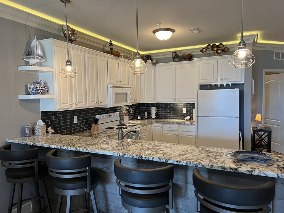 Modern bar stools and quartz granite bar counter give extra space for dining in.