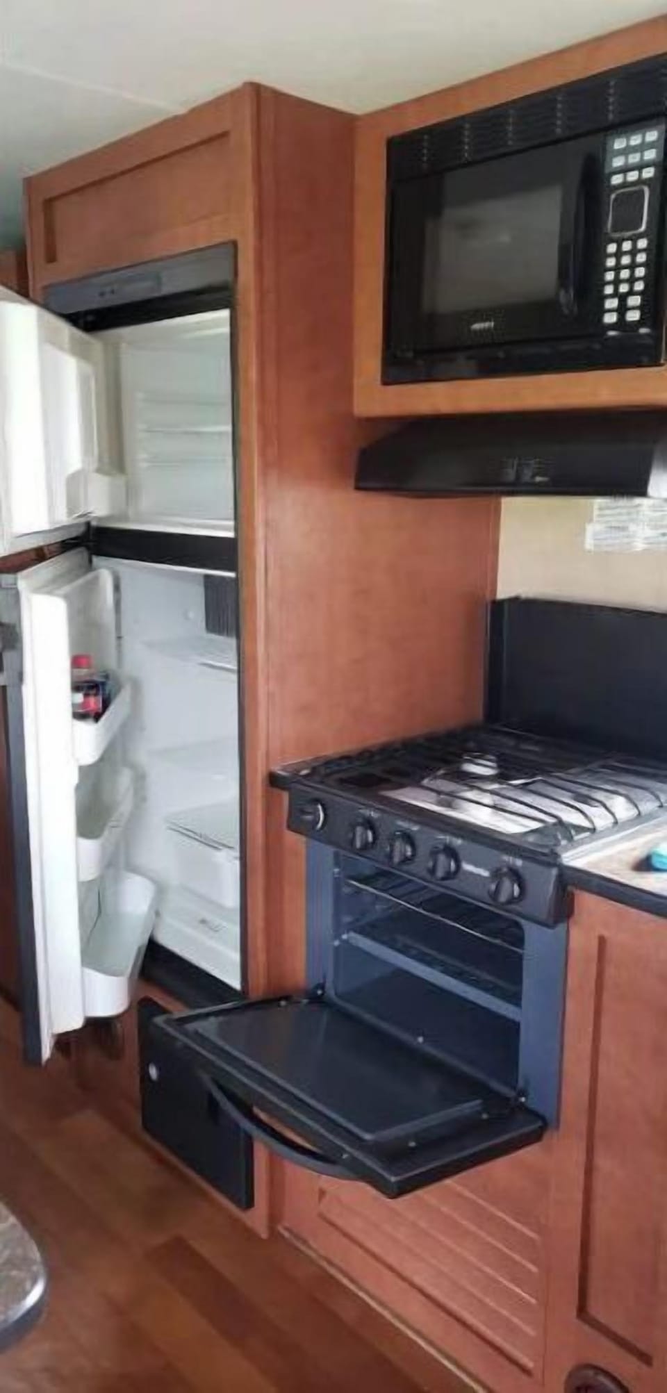 Refrigerator / Freezer, Oven with 3 burners, Microwave oven.  
