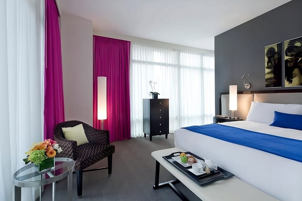 Unwind with in-room refreshments beside soft linens and warm lighting