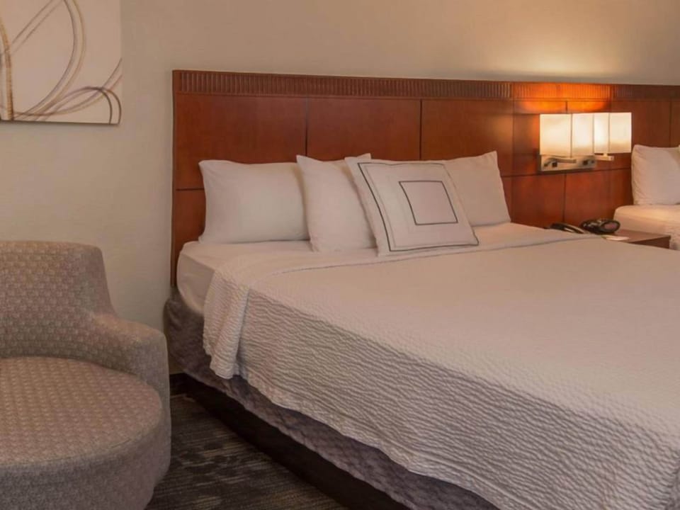 Drift off easily on a cloud-soft bed with warm lighting.