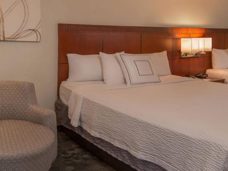 Drift off easily on a cloud-soft bed with warm lighting.