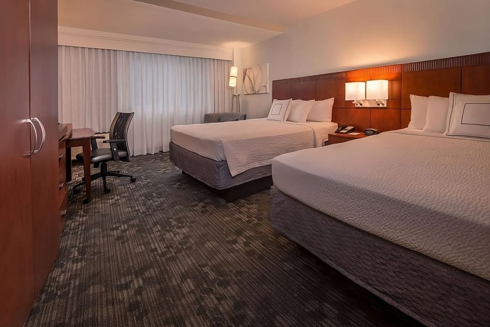 Recharge with extra space, blackout drapes, and comfortable bedding.