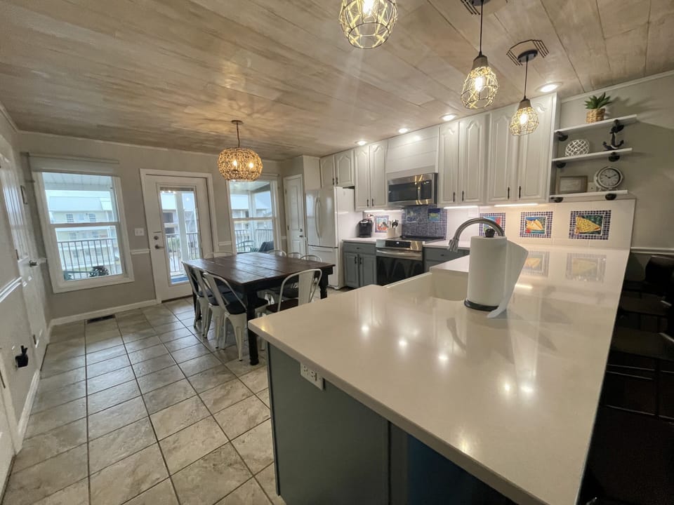 Open kitchen area with screened in deck with ocean views.
