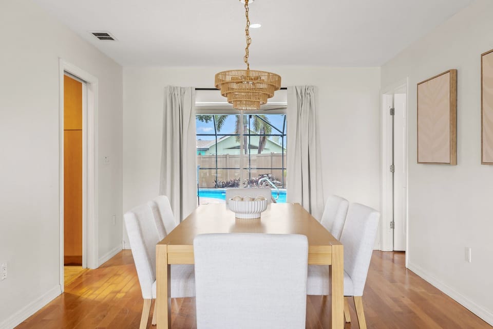 Dining Room: Bright space with pool views, perfect for memorable meals and gatherings!