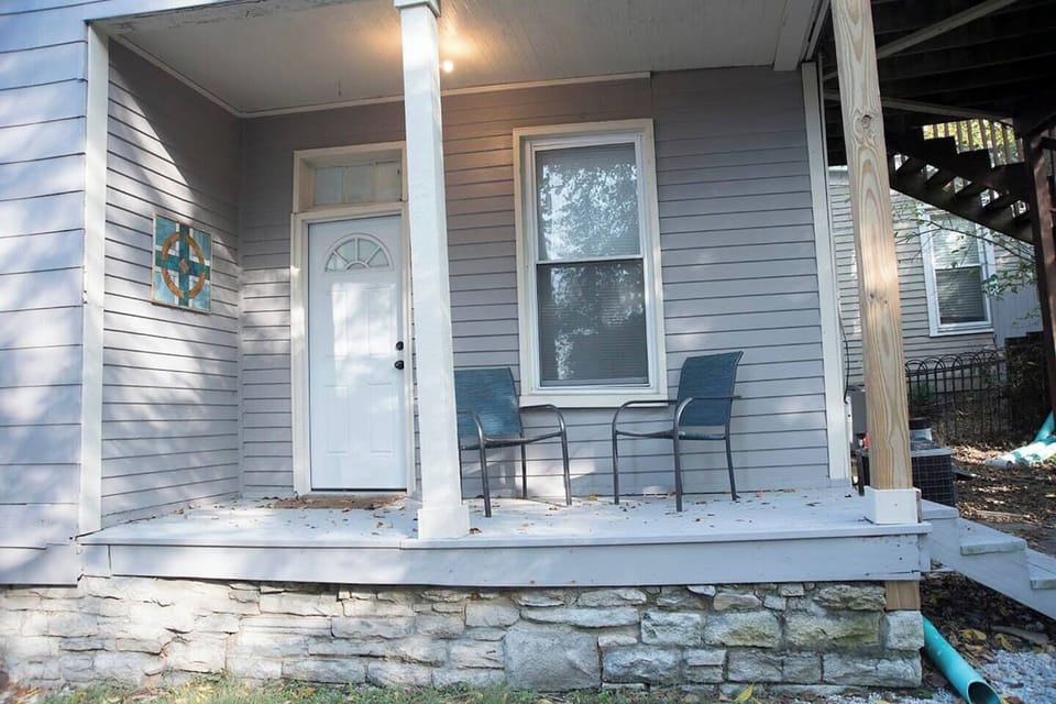 Cozy porch off the bedroom with 2 chairs to sit and enjoy your coffee.