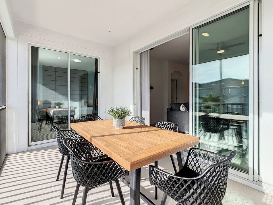 Covered Balcony with Outdoor Dining Table and Seating