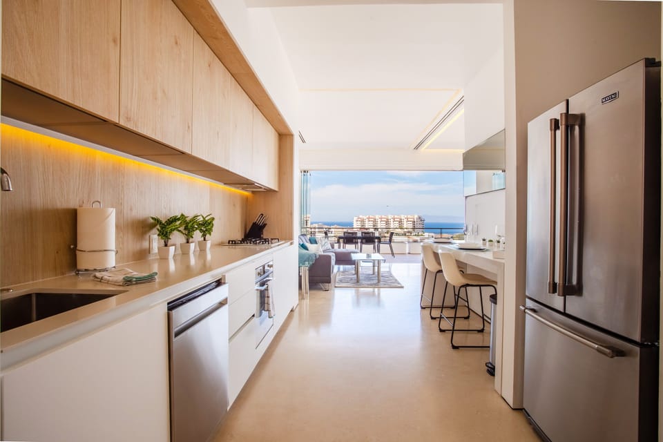 The kitchen is equipped with stove, oven, 2-door fridge and dishwasher