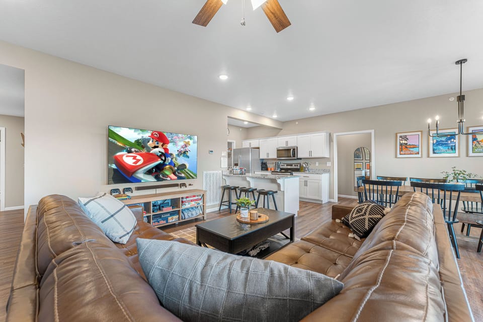 The living room holds a 75" TV with a Nintendo Switch.