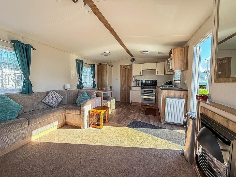 Cosy up next to the fireplace with your furry friend in this pet friendly caravan after a day of exploring by the Hunstanton beach.