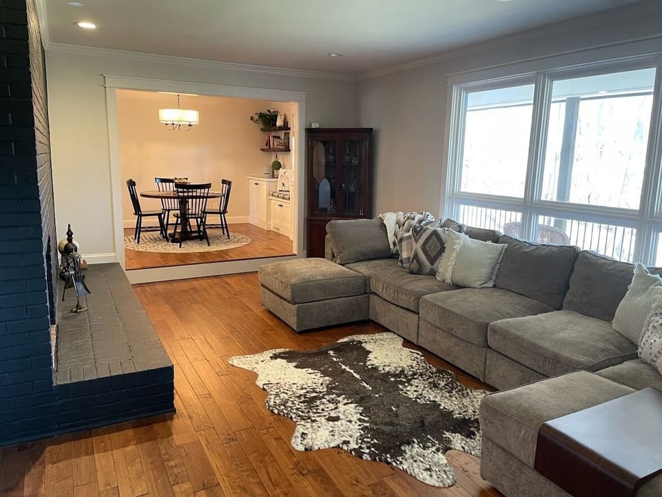 Living room with 13' LoveSac sofa and gas log fireplace. 