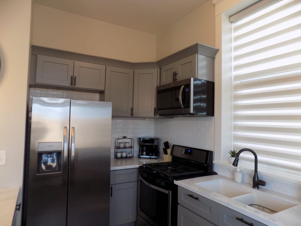 Kitchen with fridge, microwave, stove/oven, dishwasher, keurig/coffee maker