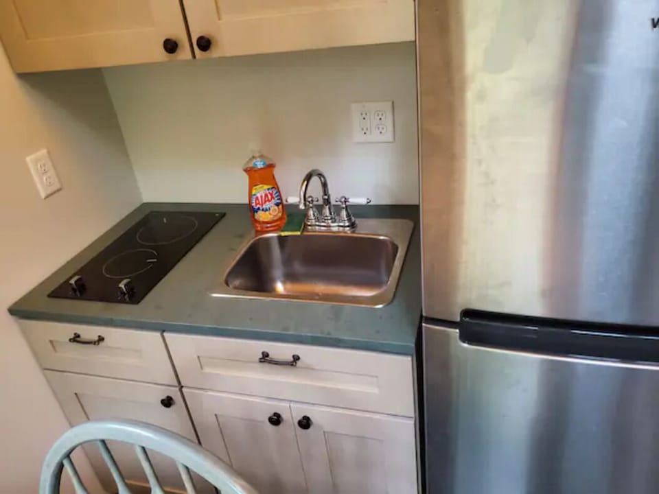 Kitchenette with two burners & fridge; equipped with dishes, pans, etc.