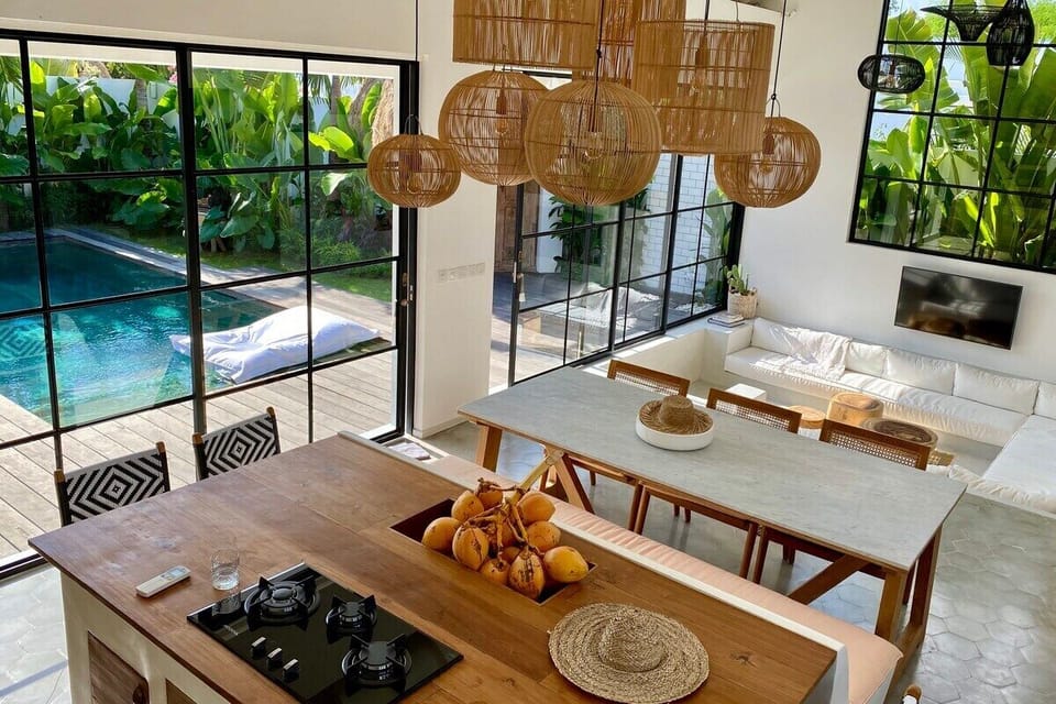 The kitchen island with gas cooktop looking down toward the sunken lounge and large glass window. Recessed coconut, fruit or flower box built into the teak kitchen island.  High speed WiFi.