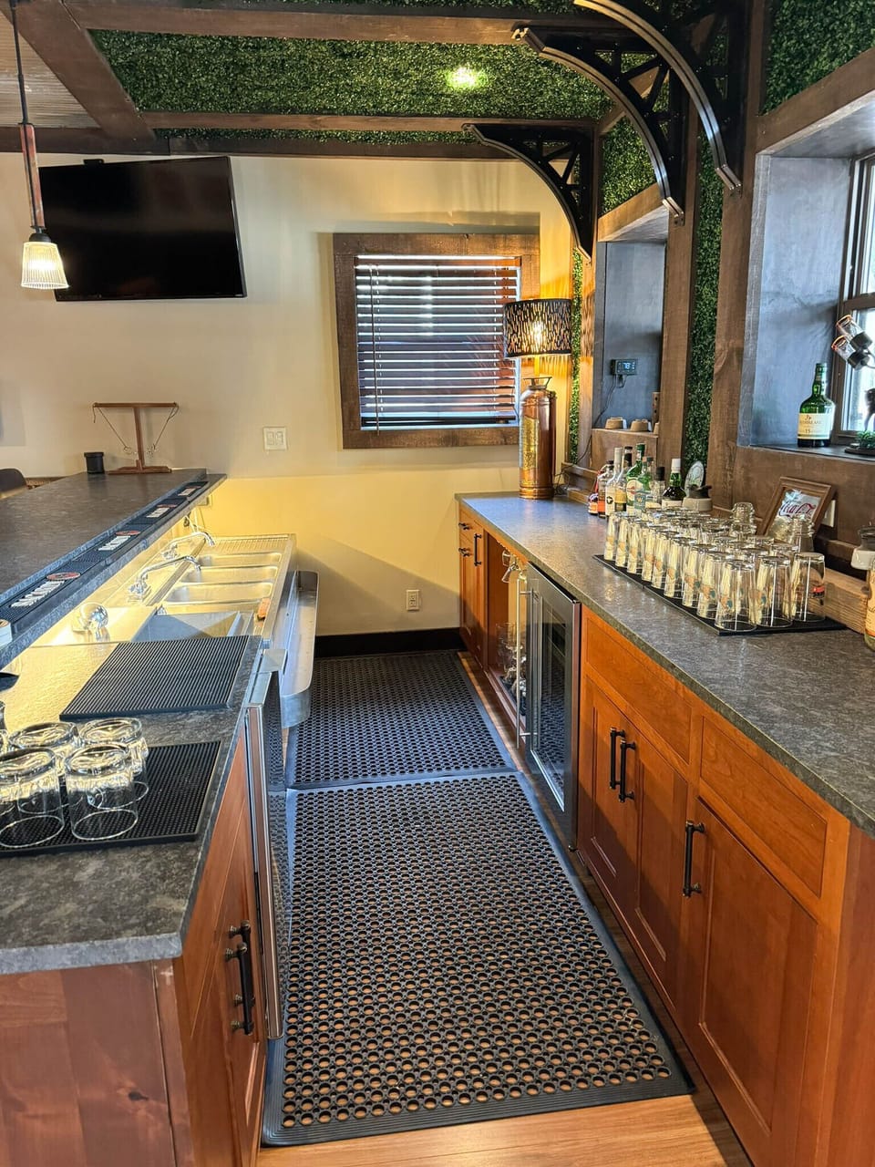 This bar comes with a full commercial set up including an under bar beverage refrigerator, ice maker, ice bin, and four compartment sink with glass washer.  Alcohol not included and shown here for illustrative purposes only.  