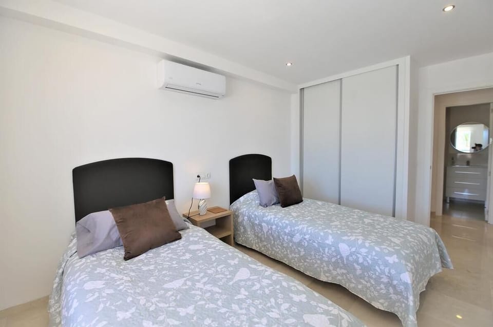 Another view of the twin bedroom with fitted wardrobes