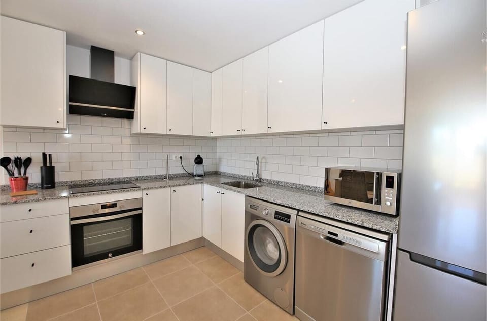 Modern open kitchen is fully fitted with all the appliances
