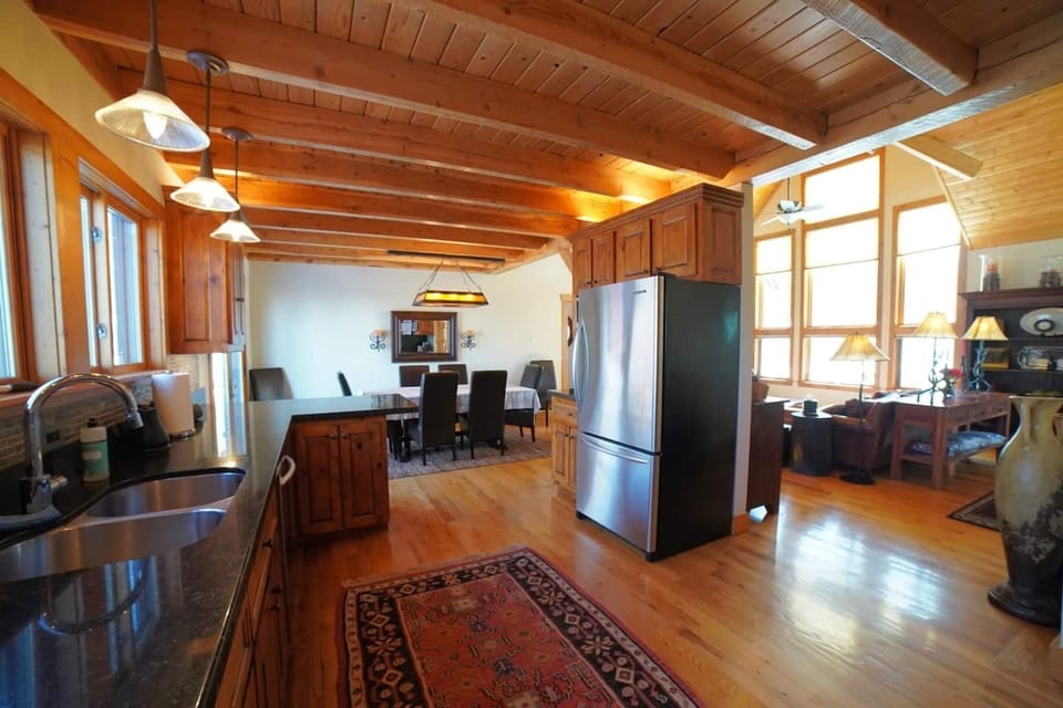Whether you are relaxing in the living room, eating at the dining room table, or hanging in the kitchen, you are always a part of the fun in this home. 