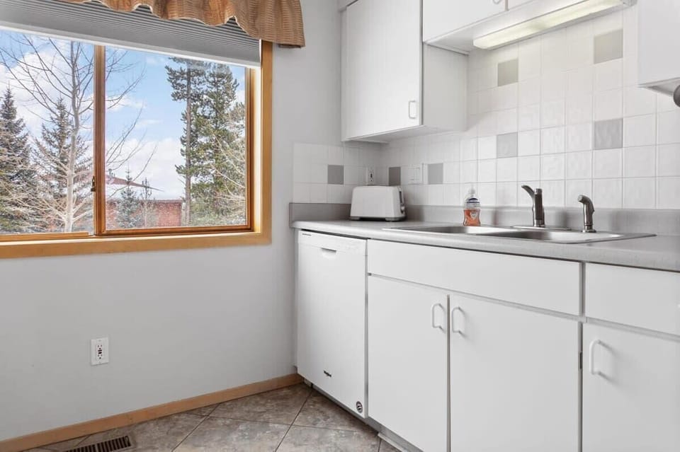 The kitchen is a light-filled space with a large window providing some tranquil views while you prepare your meal.